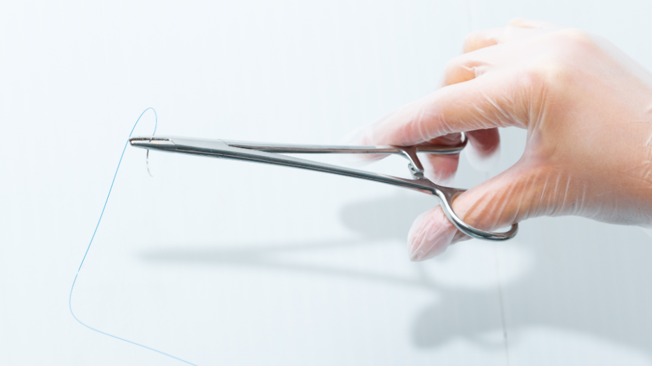 CityMD urgent care doctor holding suture scissors for when patients need stitches