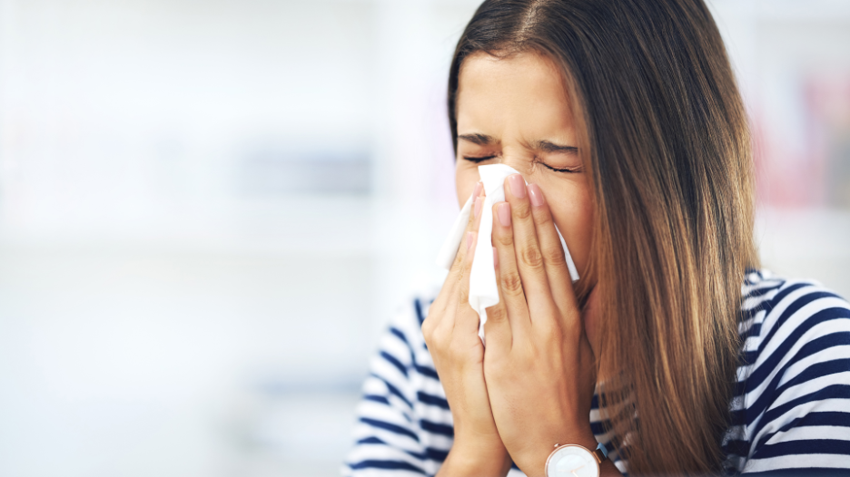 Woman blowing nose during allergy season