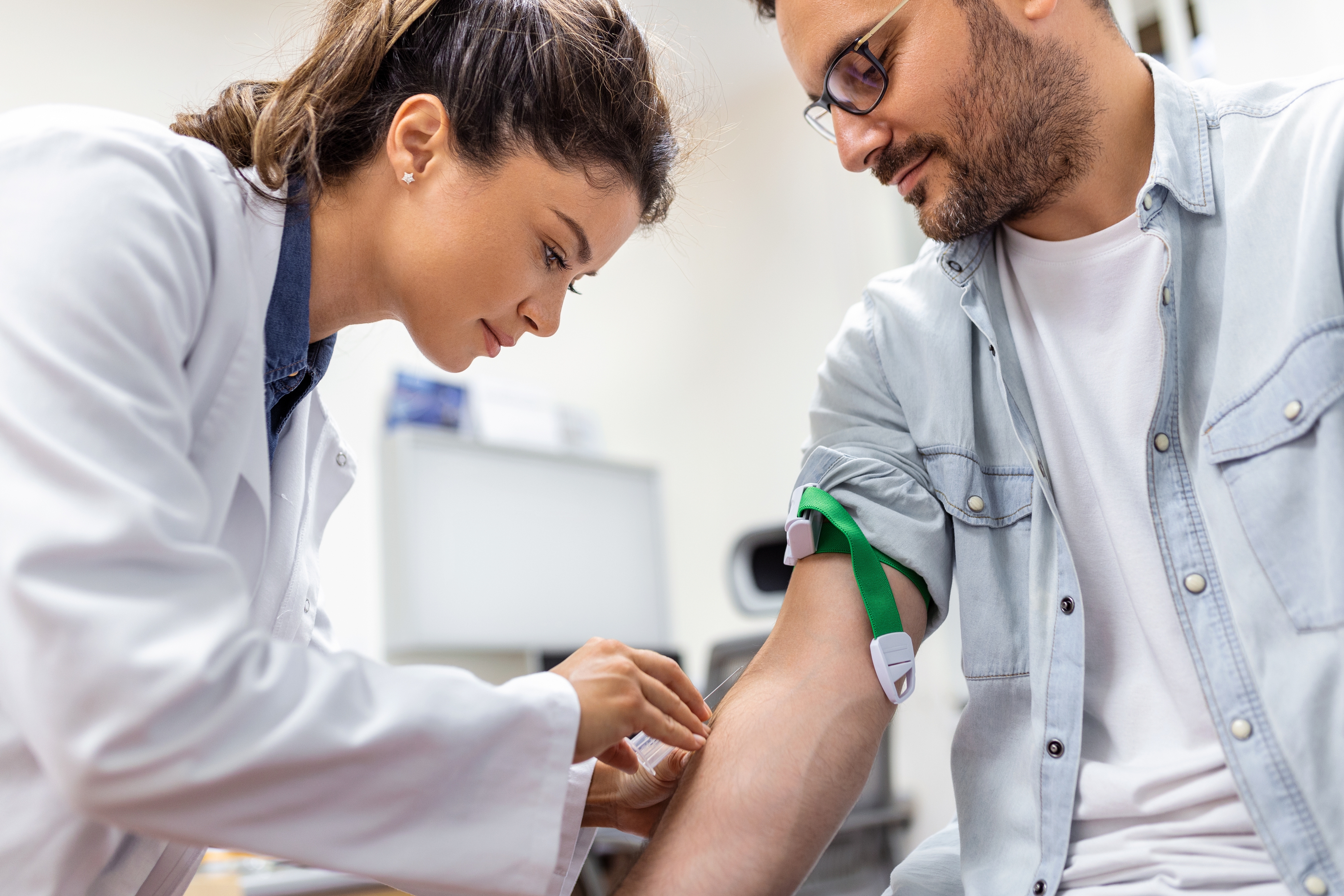 Doctor performing screening test on male patient