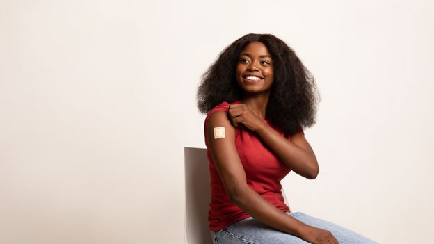 Young woman with a bandaged arm after getting vaccinated at CityMD.