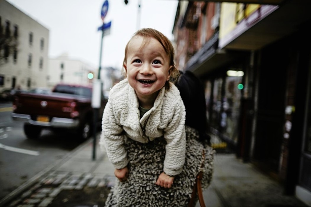 Woman holding smiling child