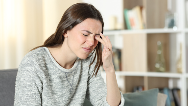A woman dealing with a foreign object in her eye