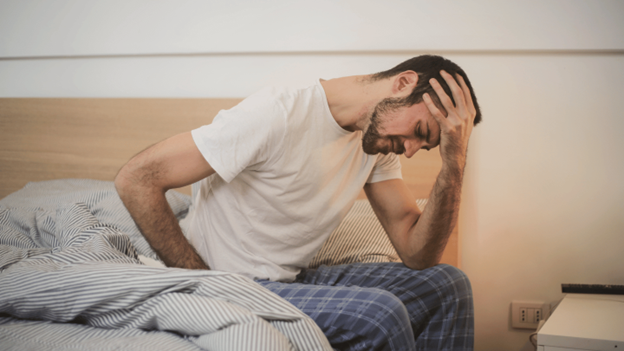Man experiencing headaches when he wakes up
