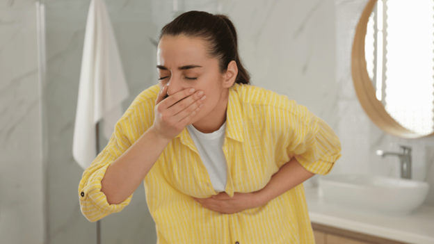 Woman experiencing norovirus symptoms after the norovirus incubation period