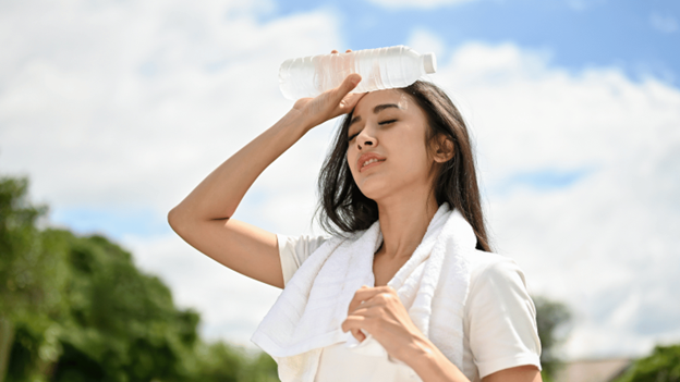 Woman outside experiencing symptoms of heat exhaustion