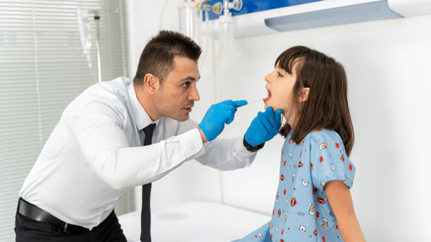 CityMD doctor performing rapid strep throat test on child using throat swab at urgent care clinic