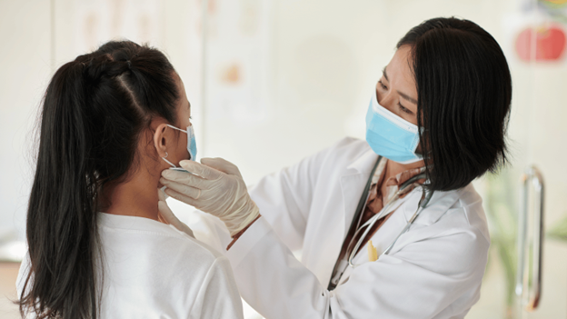 CityMD doctor examining a girl’s swollen glands in the neck
